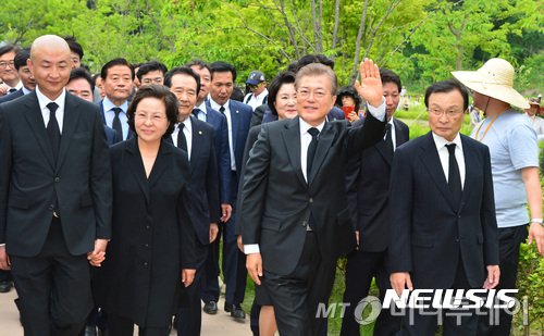 【김해=뉴시스】전진환 기자 = 문재인 대통령이 23일 오후 경남 김해시 진영읍 봉하마을에서 열린 노무현 대통령 서거 8주기 추도식에 참석해 묘역으로 향하며 시민들에게 손을 흔들고 있다.  이해찬(오른쪽부터) 노무현재단 이사장, 문재인 대통령, 권양숙 여사, 노건호씨. 2017.05.23.   amin2@newsis.com  <저작권자ⓒ 공감언론 뉴시스통신사. 무단전재-재배포 금지.>