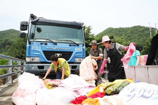 김정숙 여사가 2017년 7월 충북 청주의 수해현장을 찾아 복구활동을 돕고있다./사진=청와대 제공