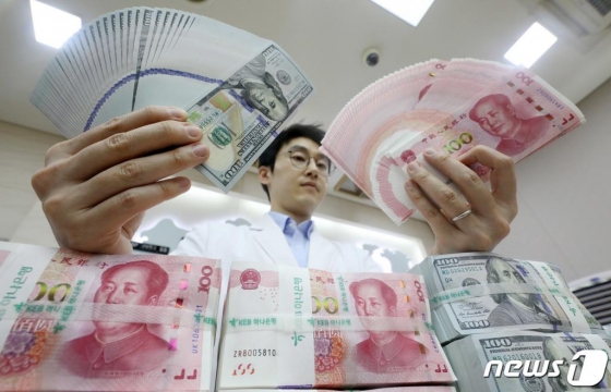 6일 오후 서울 중구 KEB 하나은행 위변조대응센터에서 직원이 미국 달러와 중국 위안화 지폐를 점검하고 있다.   미국 재무부가 5일(현지시간) 중국을 환율 조작국으로 지정했다. 중국 환율 조작국 지정은 1994년 이후 처음으로 전문가들은 이번 조치로 미중이 환율전쟁을 벌이며 무역분쟁이 더 격화될 수 있다고 내다봤다. 2019.8.6/뉴스1