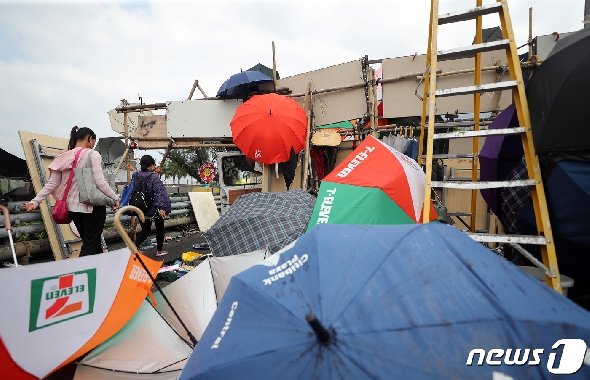 16일 오전 홍콩 중문대학교 시위 현장에 세워진 바리게이트 앞으로 시민들이 지나가고 있다. 2019.11.16/뉴스1 © News1 이재명 기자