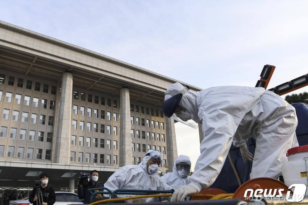 (서울=뉴스1) 김명섭 기자 = 24일 오후 서울 여의도 국회 본청 인근에서 코로나19 방역 관계자들이 방역작업을 하고 있다. 국회는 신종 코로나바이러스 감염증(코로나19) 확산 사태와 관련, 24일 오후 6시부터 26일 오전 9시까지 국회 본관과 의원회관을 폐쇄하기로 했다. 국회가 감염병 때문에 폐쇄되는 것은 이번이 사상 처음이다. 2020.2.24/뉴스1   <저작권자 © 뉴스1코리아, 무단전재 및 재배포 금지>