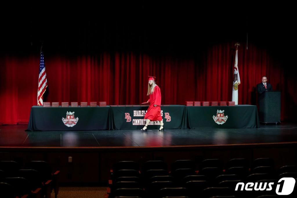 (AFP=뉴스1) 이동원 기자 = 6일(현지시간) 미국 일리노이주 브래들리에 있는 부르본나이스 커뮤니티 고등학교에서 한 학생이 졸업식에 참석하고 있다.   미국에서 고등학교와 대학교 졸업식은 결혼식이나 출산만큼이나 중요하게 여기고 있다. 코로나19 사태가 미국 사회 곳곳의 생활모습을 바꿔놓고 있다.  ⓒ AFP=뉴스1