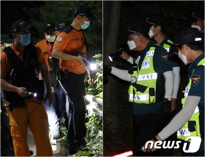 (서울=뉴스1) 이동해 기자 = 박원순 서울시장이 연락두절된 9일 저녁 북악산 일대에서 특수대응단 소방대원(왼쪽), 경찰 병력이 2차 야간 수색 작업을 하고 있다. 2020.7.9/뉴스1