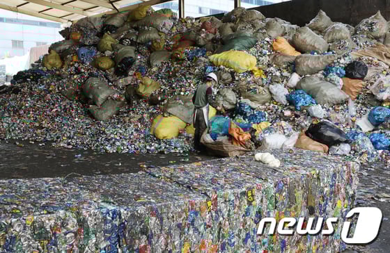 (사진=뉴스1) 송원영 기자신종 코로나바이러스 감염증(코로나19) 재확산으로 인한 '언택트' 소비로 재활용 쓰레기가 늘어가고 있는 가운데 8일 서울 송파구 송파자원순환공원에서 직원들이 재활용품 분류작업을 하고 있다. 6개월 넘게 이어지는 '코로나19 사태'로 일회용품 사용량이 급증하면서 환경에 악영향을 끼칠 수 있다는 우려가 커지고 있다. 더욱이 최근 감염 재확산에 따라 정부는 물론, 개인들도 환경과 위생 사이에서 딜레마를 겪는 모양새다. 코로나19로 일회용품 사용이 불가피해지면서 가능한 재활용률을 높이는 깨끗한 분리배출이 중요하다. 2020.9.8/뉴스1   sowon