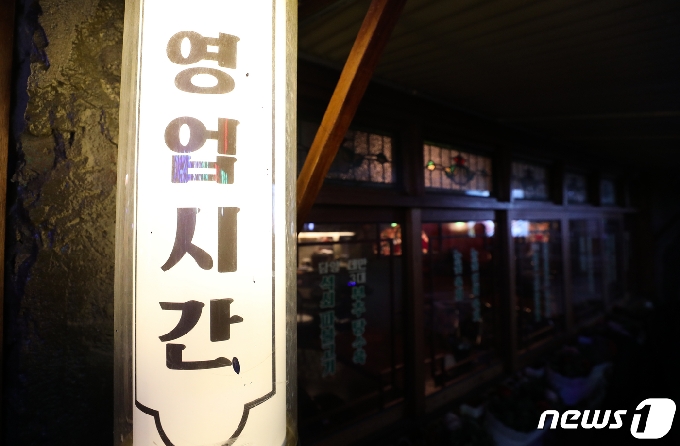 수도권 사회적 거리두기가 2단계로 격상된 24일 저녁 서울 신촌의 한 식당 안에 불이 꺼져 있다. 2단계에선 카페는 포장과 배달만 허용되고 음식점은 밤 9시 이후 포장과 배달만 가능하며 룸살롱 등 유흥시설 5종은 집합금지가 내려졌다. 2020.11.24/뉴스1 © News1 허경 기자