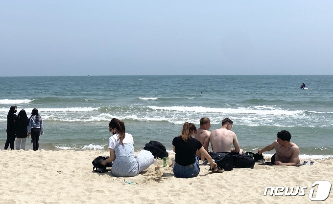 해운대해수욕장을 찾은 외국인들이 휴식을 취하고 있다.2021.6.6/© 뉴스1 박세진 기자