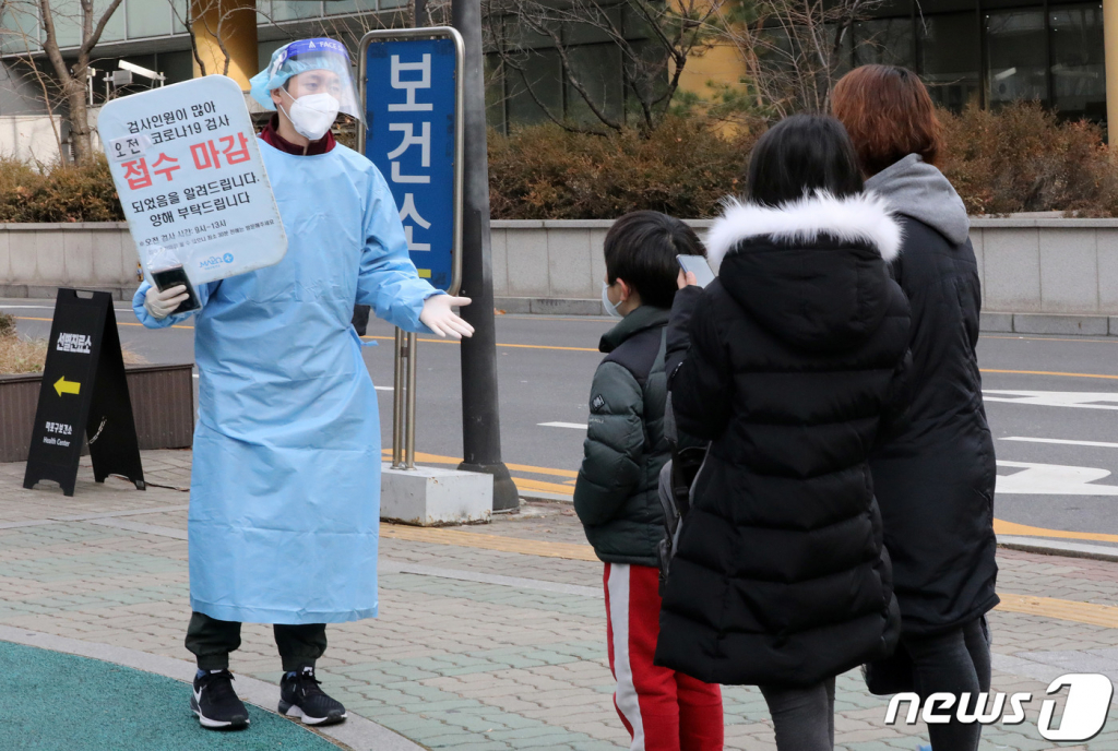 (서울=뉴스1) 박세연 기자 = 9일 오전 서울 마포구 마포구청에 마련된 코로나19 선별진료소를 찾은 시민들이 관계자에게 오전 검사 접수마감을 안내받고 있다. 이날 코로나19 확진자는 7102명 발생, 위중증 환자는 857명으로 역대 최다를 기록했다. 2021.12.9/뉴스1