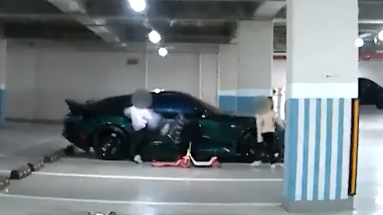 한 아파트 주차장에서 여자아이 두 명이 주차된 차를 빙빙 돌면서 발로 차는 모습 /사진=유튜브 한문철 TV