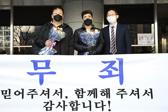 ‘낙동강변 살인사건’ 범인으로 지목돼 21년간 옥살이를 한 장동익씨와 최인철씨가 4일 오전 부산 연제구 부산고등법원에서 열린 재심 선고 공판을 마친 후 박준영 변호사와 기념촬영을 하고 있다. 2021.2.4/뉴스1