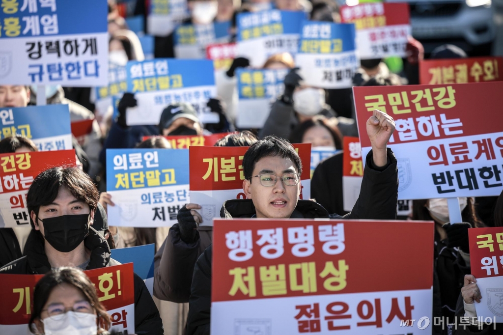 [서울=뉴시스] 정병혁 기자 = 8일 서울 종로구 대학로에서 열린 서울대병원 전공의협의회 비상대책위원회 ‘젊은 의사 의료계엄 규탄 집회’에서 사직 전공의를 비롯한 젊은 의사들이 피켓을 들고 있다. 2024.12.08. jhope@newsis.com /사진=정병혁