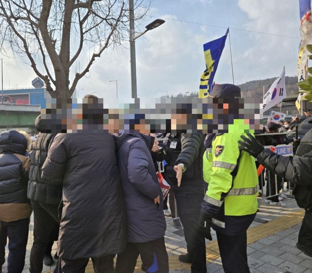 20일 오후 2시30분쯤 서울 용산구 한남동 대통령 관저 앞에서 신자유연대측 집회 참가자가 헬조선변혁전국추진위원회쪽 집회 장소에 다가서자 경찰이 제지하고 있다.이 과정에서 두 단체간 욕설과 고성이 오갔다./사진=이찬종 기자