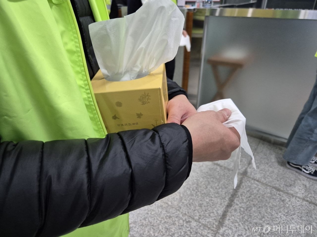 31일 전남 무안국제공항 1층에 마련된 합동분향소 앞에서 휴지를 들고 기다리는 자원봉사자./사진=박진호 기자