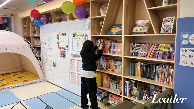 ▲한 아이가 강동어린이식당에서 저녁식사를 한 뒤 책을 고르고 있다./사진=신재은 기자