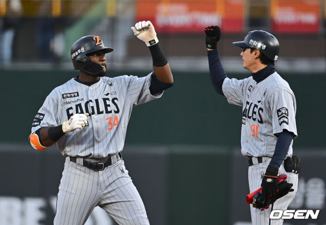 한화 플로리얼(왼쪽)이 23일 부산 롯데전 1회초 무사 1루에서 안타를 치고 기뻐하고 있다.