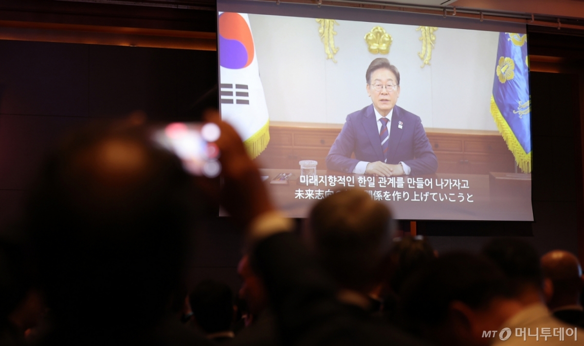 16일 서울 중구 롯데호텔에서 열린 한일 국교정상화 60주년 기념 리셉션에서 이재명 대통령의 축사 영상이 나오고 있다. / 사진=뉴스1