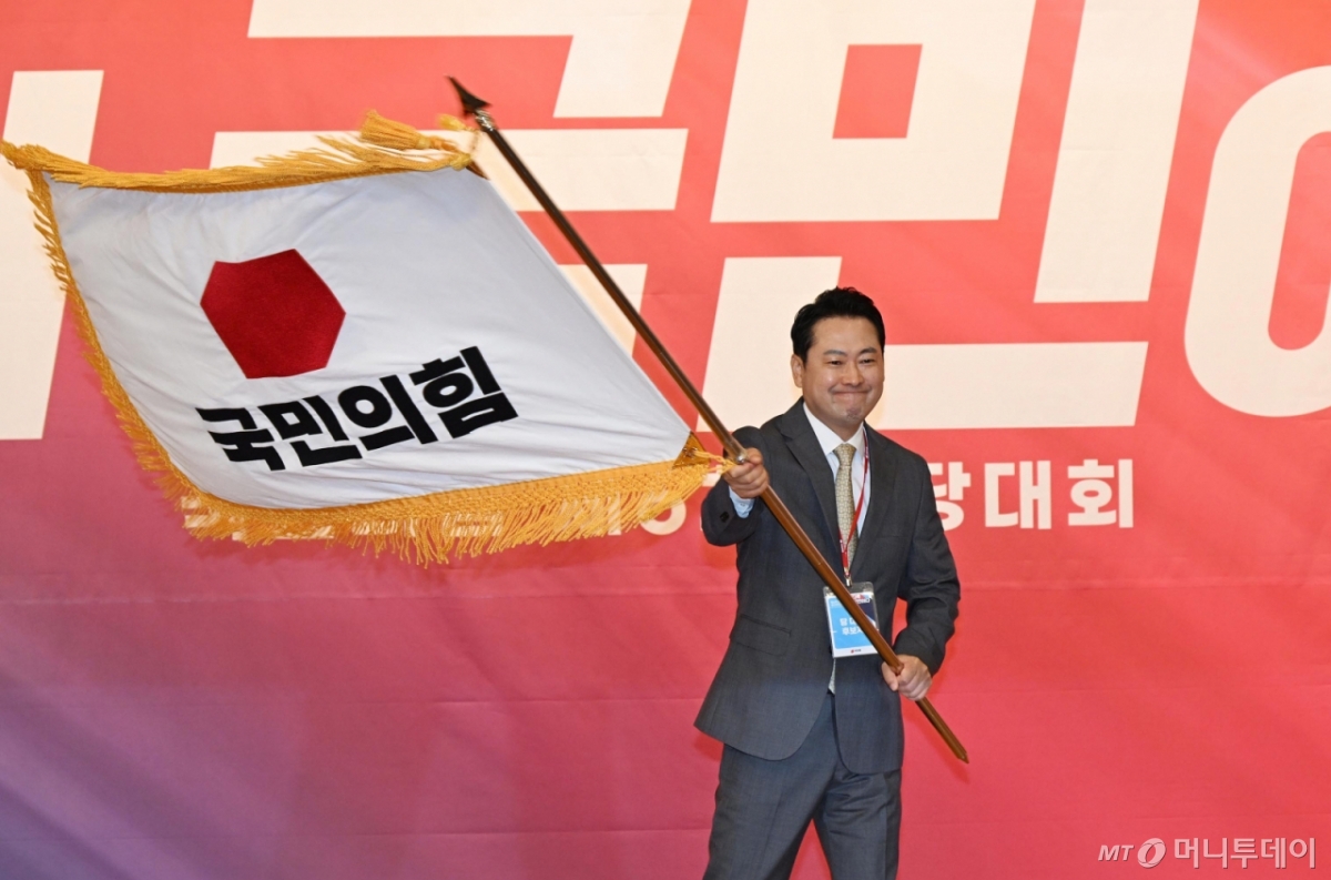 [서울=뉴시스] 국회사진기자단 = 장동혁 신임 국민의힘 대표가 26일 서울 여의도 국회도서관에서 열린 국민의힘 제6차 전당대회 결선에서 선출된 뒤 당기를 흔들고 있다. 2025.08.26. photo@newsis.com /사진=류현주