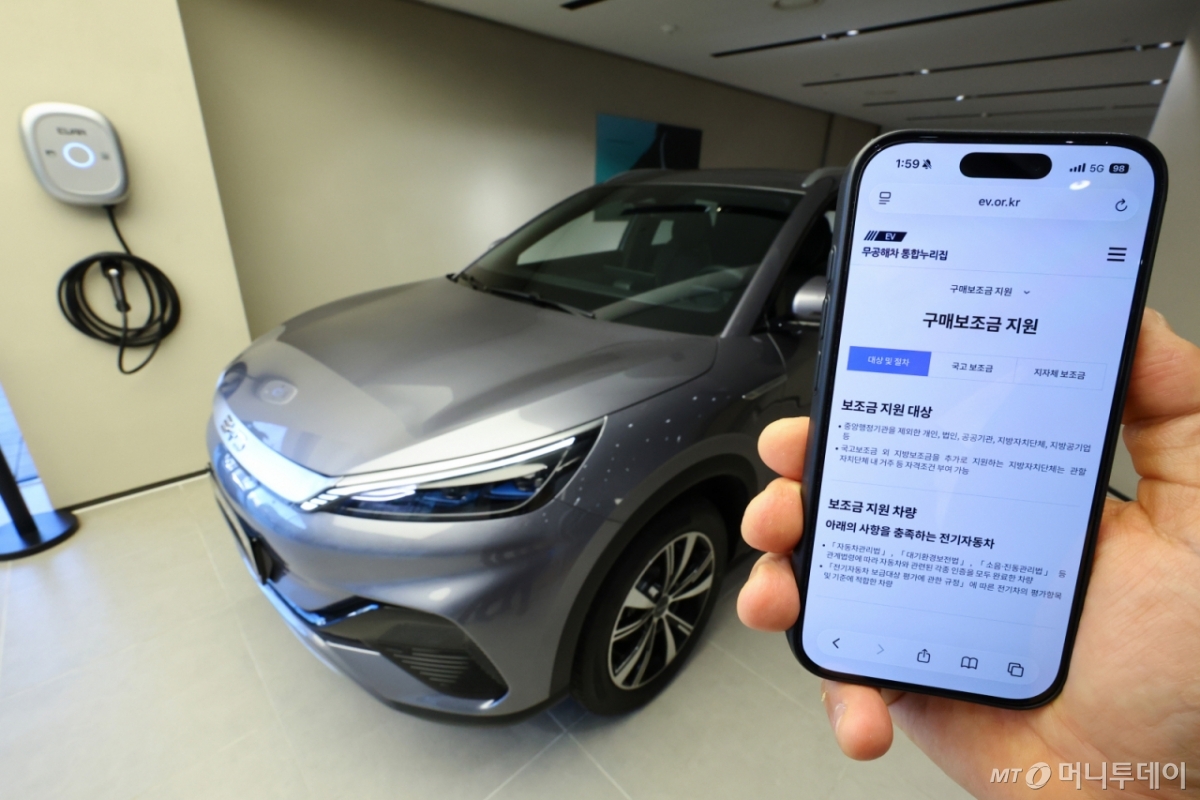 [서울=뉴시스] 황준선 기자 = 2일 서울 용산구 전기차 브랜드 BYD 매장을 찾은 고객이 전기차 구매보조금 지원 제도를 살펴보고 있다.