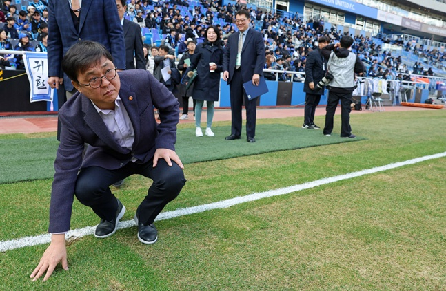 최휘영 장관이 인천축구전용경기장의 잔디 상태를 살펴보고 있다.  /사진=문체부