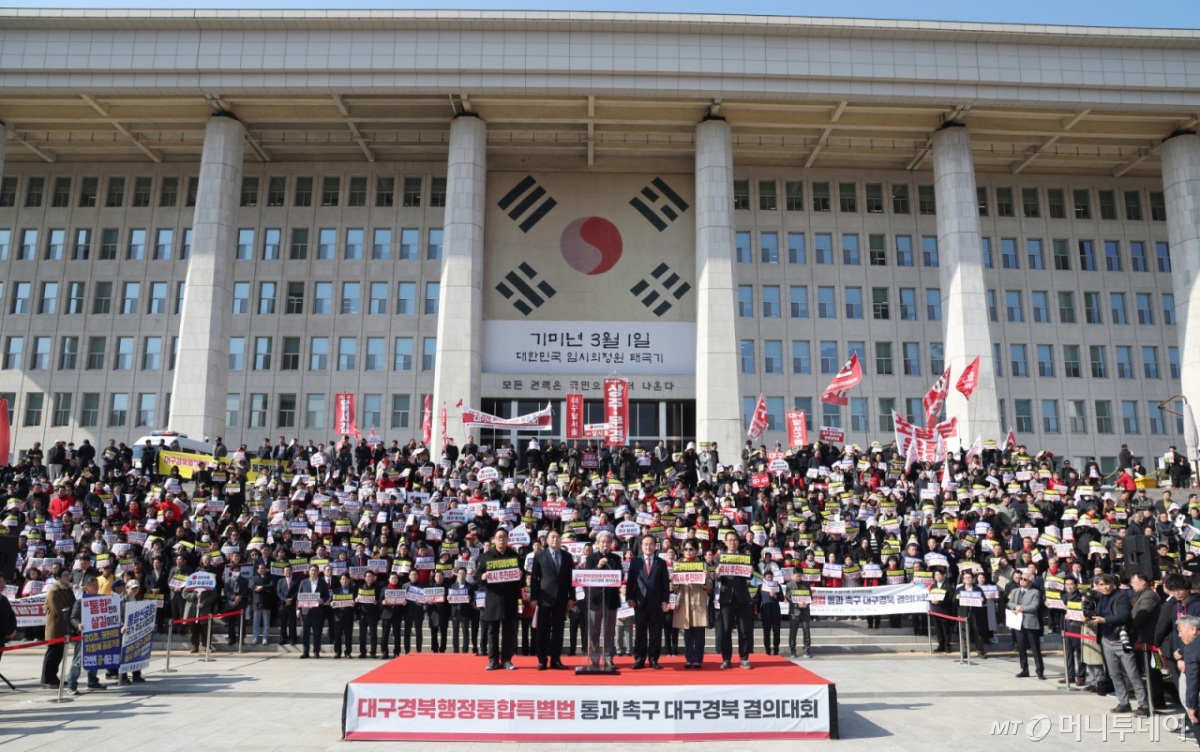 (서울=뉴스1) 신웅수 기자 = 대구·경북 지역구 국민의힘 의원들이 4일 서울 여의도 국회 본관 앞에서 열린 대구경북 통합법 처리 촉구 결의대회에서 참가자들과 함께 구호를 외치고 있다. 2026.3.4/뉴스1 Copyright © 뉴스1. All rights reserved. 무단 전재 및 재배포, AI학습 이용 금지. /사진=(서울=뉴스1) 신웅수 기자