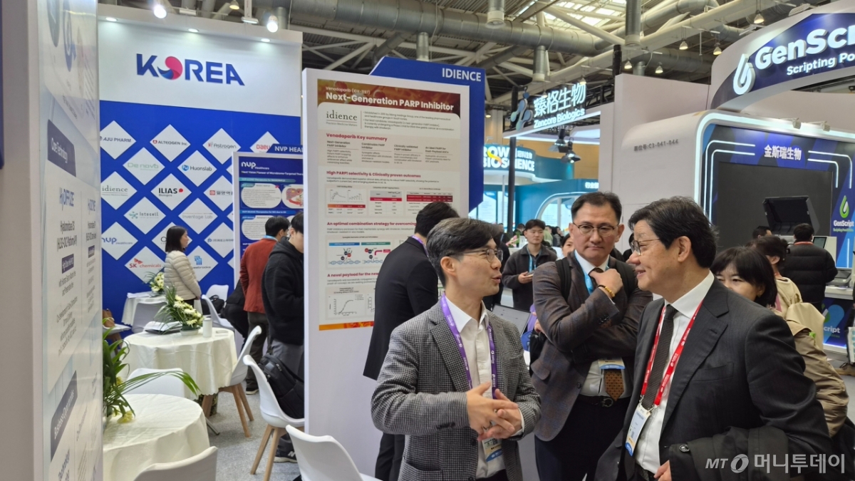노연홍 한국제약바이오협회장(오른쪽)이 12일 바이오 차이나 2026에 설치된 한국관에서 참가기업인 휴온스랩의 이병하 전무(왼쪽)로부터 설명을 듣고 있다./사진= 박미주 기자