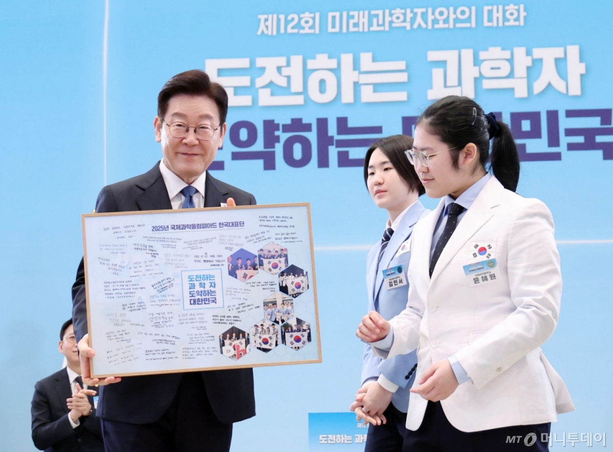 이재명 대통령이 지난달 청와대에서 열린 대통령과학장학생·올림피아드 대표단 친수 및 간담회(미래 과학자와의 대화)에서 국제과학올림피아드 대표단에게 우리나라 도약을 이끌 미래 과학자로서 다짐을 담은 기념액자 전달을 받고 있다. /사진=뉴시스