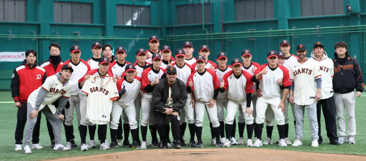 미국 메이저리그 프로야구(MLB) 샌프란시스코 자이언츠가 지난 1월 7일 경기도 이천 LG 챔피언스파크에서 휘문고 및 덕수고 선수 60여 명을 초청해 야구 클리닉을 열었다.  아다메스가 덕수고 엄준상에게 유니폼을 전달한 후 기념촬영을 하고 있다.   이날 행사에는 래리 베어 회장, 버스터 포지 사장, 토니 비텔로 감독, 이정후, 윌리 아다메스, 황재균 등이 참석했다. /사진=김진경 대기자