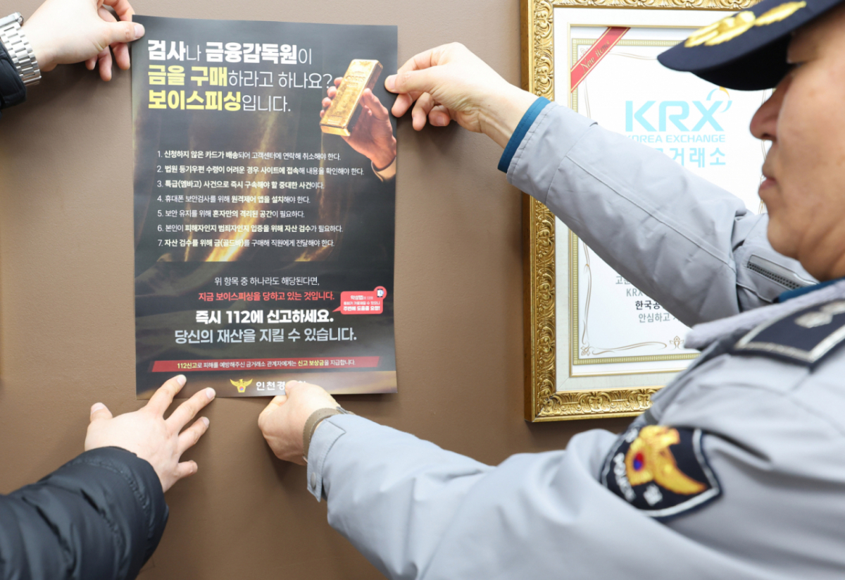인천경찰청 관할 형사와 지구대 경찰이 인천 남동구의 한국공인금거래소를 찾아 보이스피싱 범죄예방 안내문을 부착하고 있다./사진=뉴시스 /사진=전진환