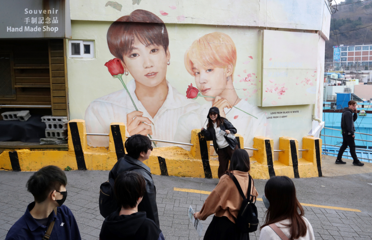 부산 서구 감천문화마을에서 외국인 관광객들이 부산이 고향인 BTS 멤버 정국·지민이 그려진 대형 벽화를 배경으로 기념촬영을 하고 있다./사진제공=뉴스1