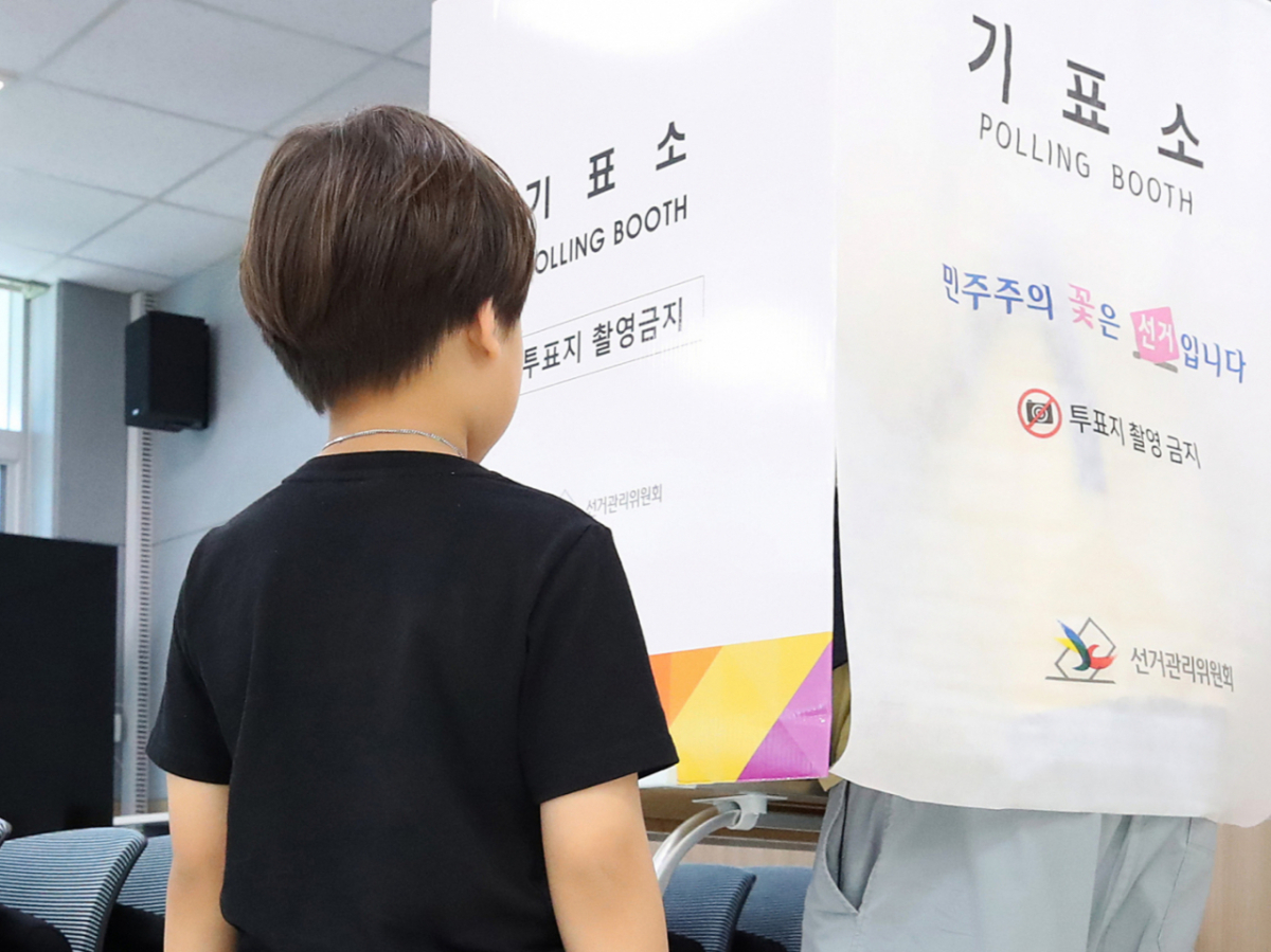지난달 30일 대구의 한 '6·3 지방선거 사전투표소'에서 8세 아들이 기표소 앞에서 투표 중인 아빠를 기다리고 있다. /사진=뉴스1