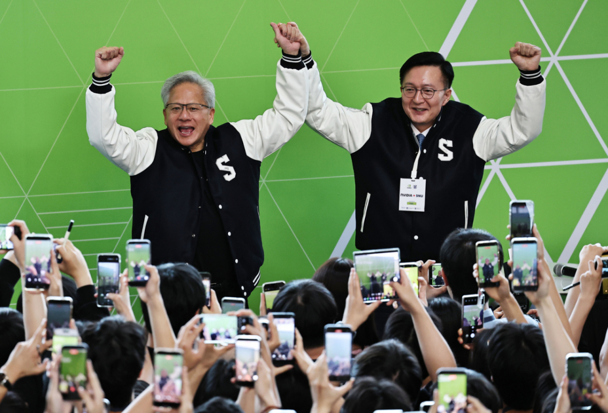 젠슨 황 엔비디아 최고경영자(CEO)가 8일 서울대학교 해동첨단공학관에서 열린 '빌드어클로(Build-a-Claw)' 행사장에서 유홍림 서울대 총장으로부터 학교 점퍼를 선물받은뒤 두손을 들어보이고 있다. /사진=뉴스1(공동취재).