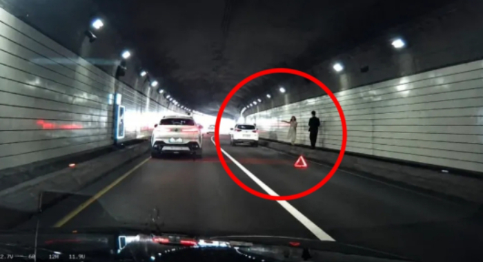 남산 3호터널에서 예비부부가 웨딩 촬영을 위해 한 차로를 막았다는 글이 SNS에 확산됐으나 사실이 아닌 것으로 드러났다. 사진 속 남녀는 대학원 졸업식에 가던 중 차량이 고장 나 수신호를 하고 있었다고 밝혔다. /사진=스레드 캡처