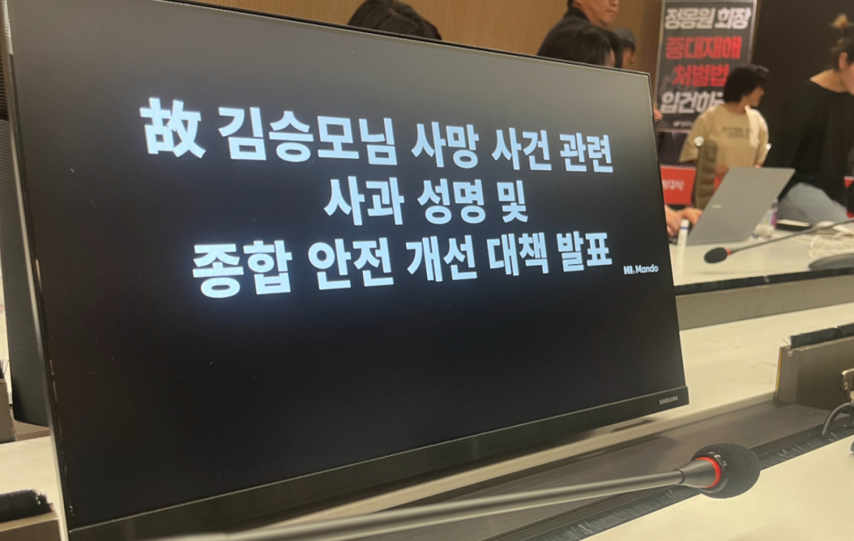 21일 경기 성남 판교 사옥에서 김승모씨 사망 사고 관련 사과 성명과 종합안전개선대책이 발표되는 가운데, 이를 저지하기 위해 유족들이 기자회견장에 입장에 피켓을 들고 있다./사진=이정우 기자
