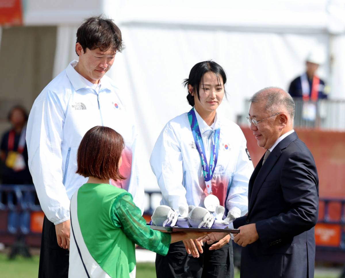 대한민국 박정윤-최용희가 30일 일본 오카자키 주오 소고 공원에서 열린 2026 아이치·나고야 아시안게임 양궁 컴파운드 혼합복식 인도와의 결승전 슛오프에서 마지막 화살이 9점을 기록하며 아쉽게 은메달에 머물렀다. 정의선 양궁협회회장이 두 선수에게 은메달을 걸어주고 있다. . 2026.09.29. /사진=강영조 cameratalks@