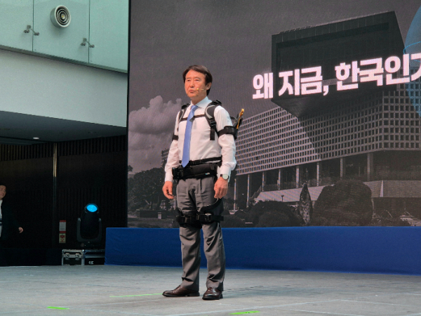 배충식 KAIST 총장이 공경철 교수가 개발한 웨어러블 로봇을 착용하고 무대에 섰다. /사진=박건희 기자