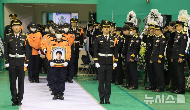 오늘(19일) 경기 부천 공장 화재 현장에서 순직한 고(故) 김진석 소방위의 영결식이 엄수됐다. 이날 경기 부천 원미구 부천체육관에 열린 '고(故) 김진석 소방위 영결식'에서 고인의 운구행렬이 영결식장으로 들어서고 있는 모습./사진=뉴시스