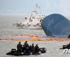 바다 위 삐죽 솟은 세월호 선두, 하늘에선 부슬비만…